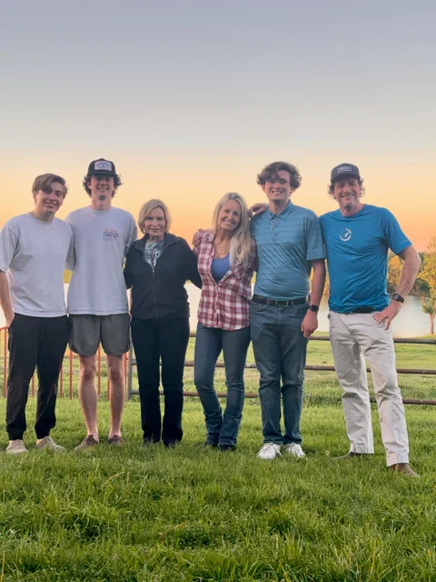 Kristy Purtle with family at sunset on ranch land